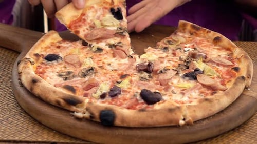Young man enjoying a tasty pizza slice at an italian pizzeria in slow motion