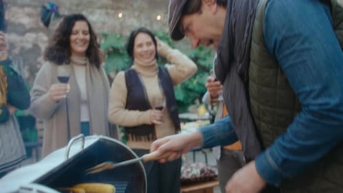 Friends Gather For Outdoor Summer Barbeque Party