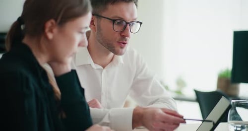 Confident Businessman and Businesswoman Discussing Strategy