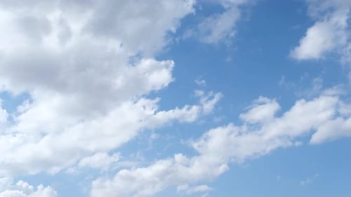 Clouds Drifting Across Blue Daytime Sky