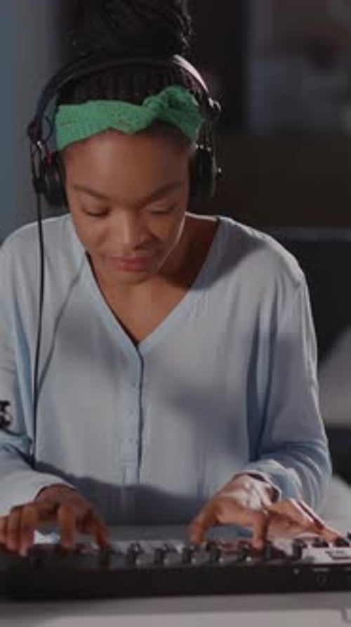 Young Woman Plays Keyboard at Home