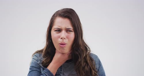 Young Woman Experiencing Sore Throat in Studio