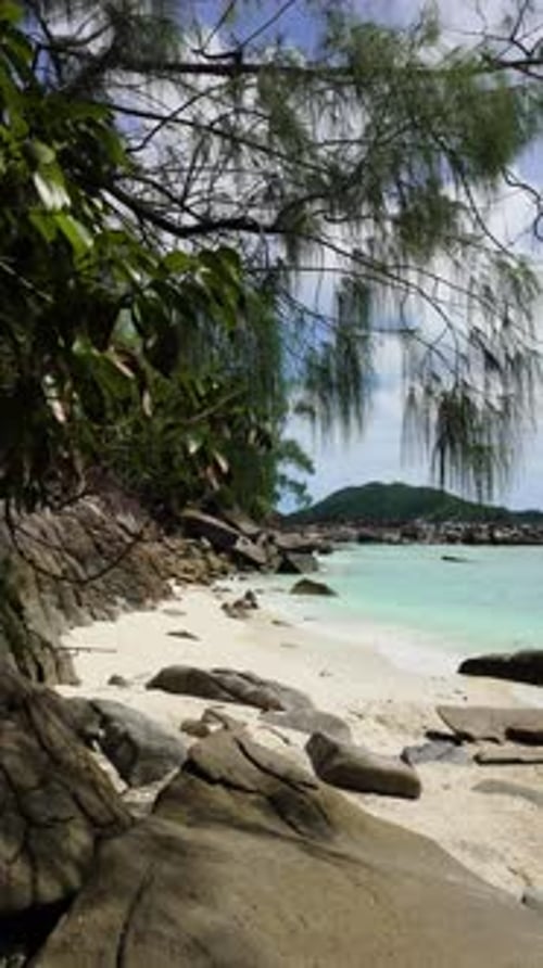 Rocky Coastline with Lush Greenery and White Sand Beach Seychelles Mahe