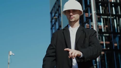 Engineer in Hardhat Gesturing at Invisible Screen