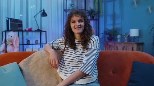 Woman Talking, Sitting on Couch in Her Home