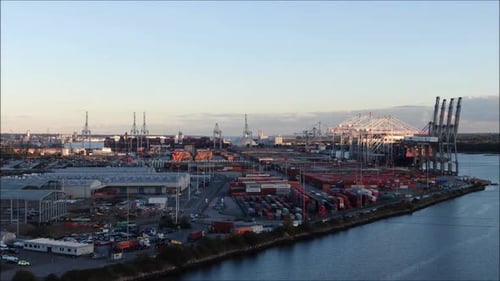 Busy Industrial Shipping Port and Logistics Hub at Golden Sunset