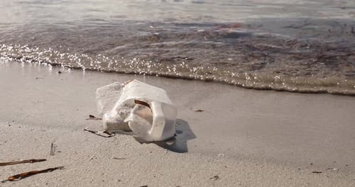 Plastic Trash Washes up on Sandy Beach