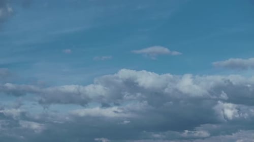 Clouds Drifting Across the Bright Blue Sky