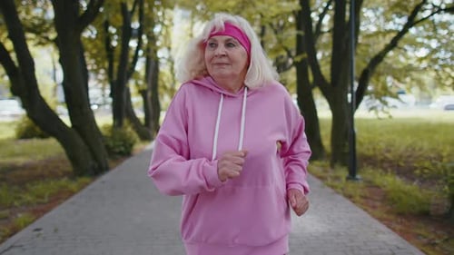 Athletic Fitness Senior Sport Runner Woman Grandmother Training Workout Cardio in Park at Morning