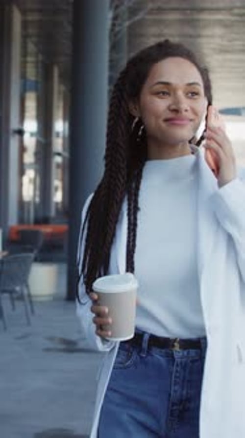 Beautiful Woman Walking Speak on Mobile Phone Hold Paper Cup Smiling Talking on Phone Relaxing