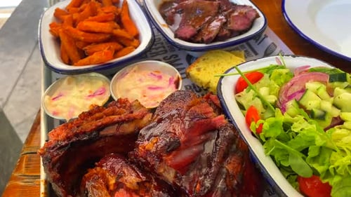 Barbecue Meat Assortment with Sides Displayed on Table