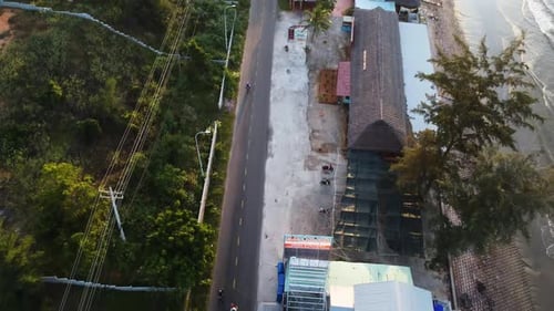 Aerial top down, rural tropical beachside town in Southeast Asia