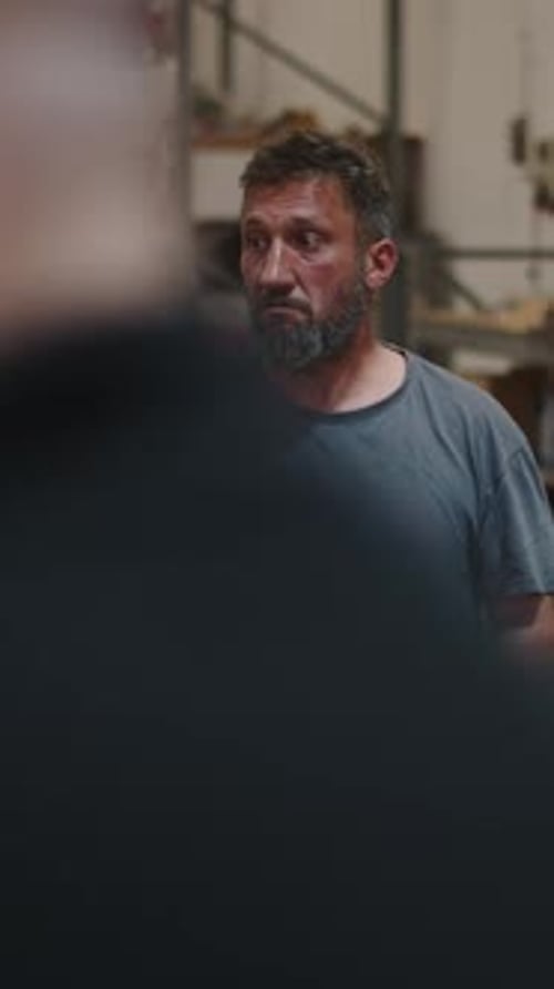 Mature Factory Worker Talking and Gesturing