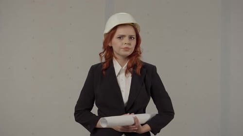 A Woman Architect Looks Around in Shock and Distress Clutching Her Head in Hopelessness Portrait of