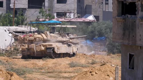 Israeli tank concealed by buildings in Rafah Palestine rotating its turret