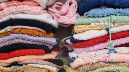 Stack of Knitted Warm Sweaters with Different Knitting Patterns