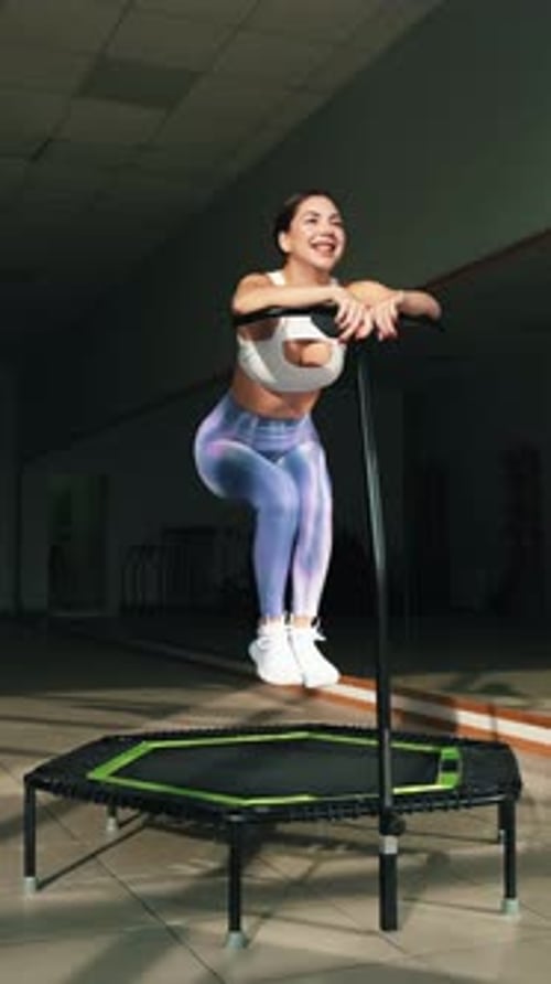 Woman Jumps on Mini Trampoline During Fitness Training