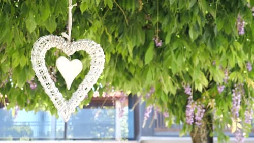 heart ornament blowing in the wing , slow motion.