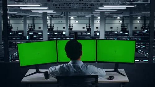 ired Asian Man Stretching While Working With Mock Up Multiple Computer Monitor In Data Center
