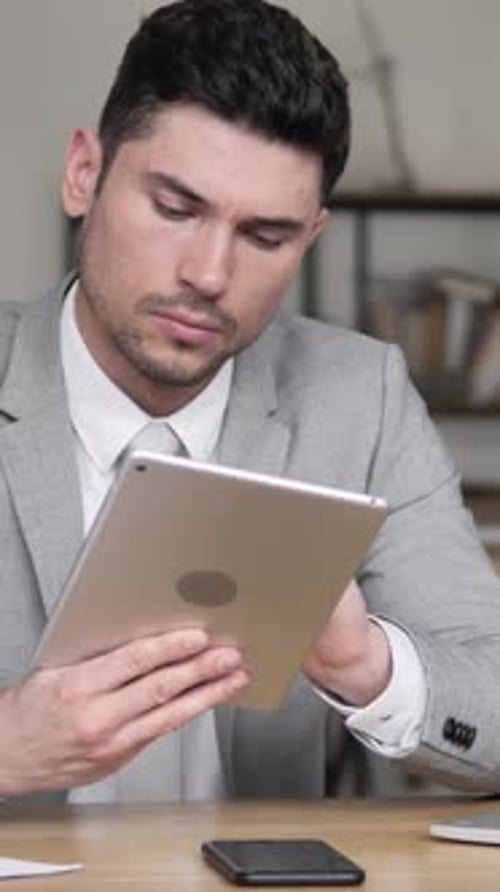 Businessman Using Tablet in Office, Vertical Video