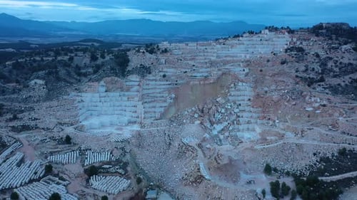 Aerial view of Open-air mining activity in a white marble mine.