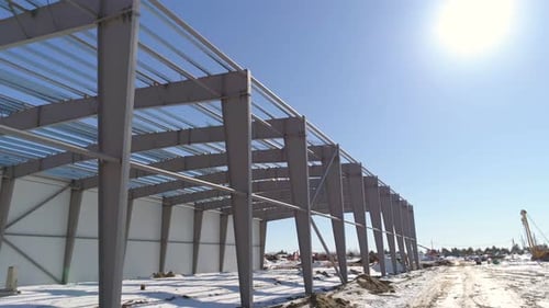 Carcass of Storehouse at Snowy Construction Site in Winter