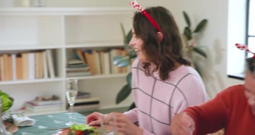 Friends Share Laughter at Christmas Dinner