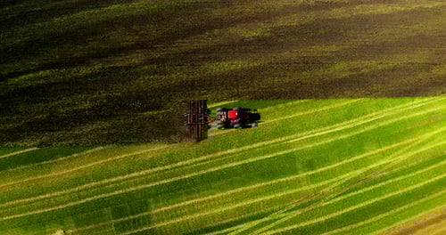 Tractor Cultivating Field at Springaerial View
