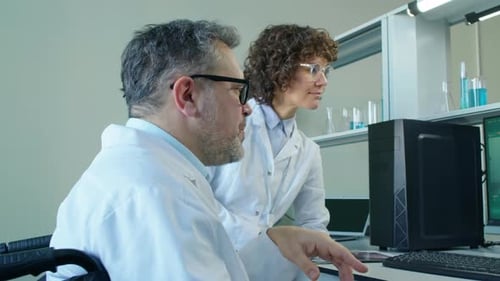 Scientists Working on Computer in Bright Laboratory