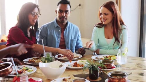Friends Eating Indian Food at Restaurant Table Together