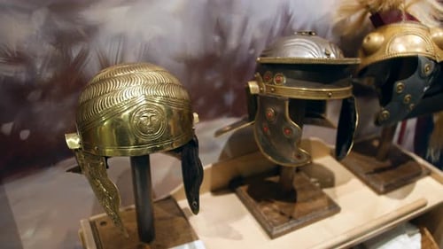 Roman helmets on display in a museum