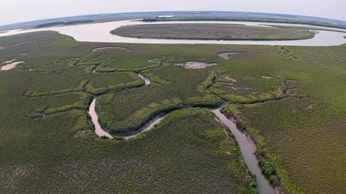 Sweeping Aerial View of Marshlands with Curving Waterways
