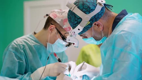 Medical team performing operation. Group of surgeons in operating theater at work