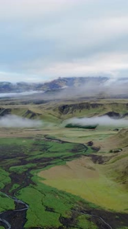 Aerial View of Iceland Displays Stunning Landscape with Clouds Mountains Showcasing Natural Beauty