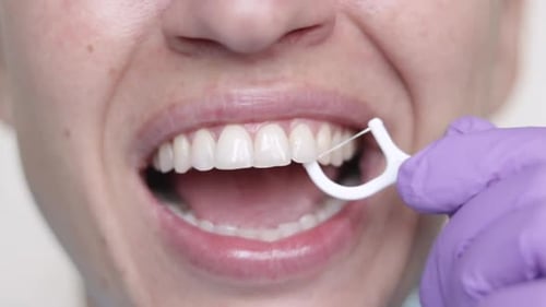 Close Up of Woman Flossing Teeth