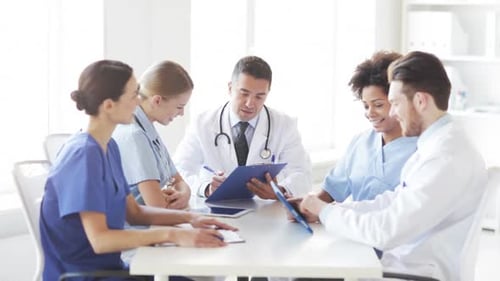 Hospital, Profession, People and Medicine Concept - Group of Doctors with Board