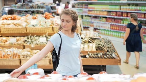 Woman Shops for Produce at Grocery Store