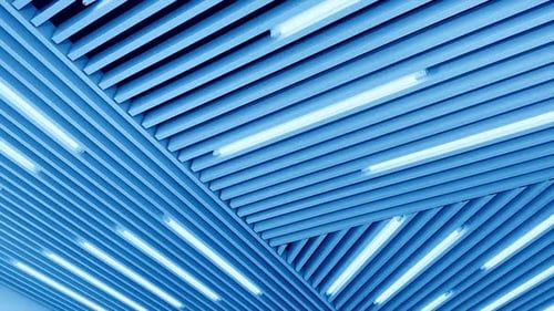 Led lamps on the unusual ceiling. Day light switched on. Low angle view.