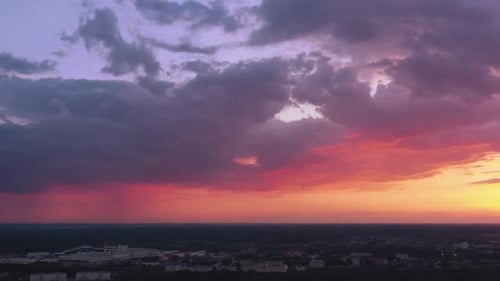 Dramatic Sunset Over an Urban Skyline, Aerial View