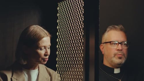 Priest and Senior Woman Having Conversation during Confession