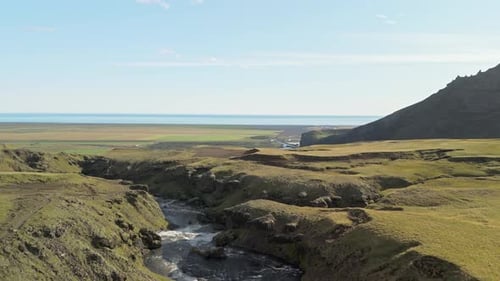 Drone View Of A Beautiful Mountain River Flowing Through An Icelandic Canyon