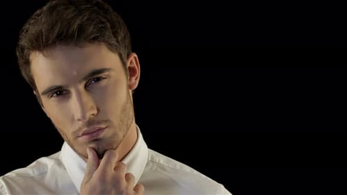 Man Touches Face in Thoughtful Pose