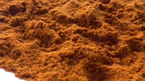 Pile of Brown Orange Spice Powder Close Up