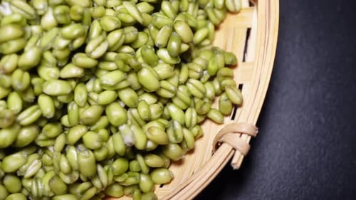 Green coffee beans in coffee bag made from burlap on wooden surface
