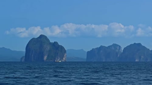 Scenic Wide Shot of Towering Limestone Islands in the Open Ocean
