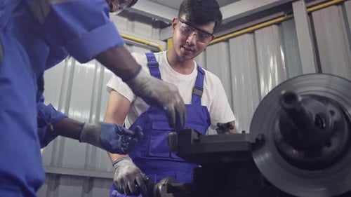 Diversity mechanic worke using metal lathe machine operate tool in the factory