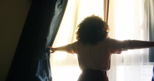 Woman Curly Hair Opening the Curtains in Her Room