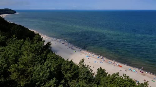 Aerial view of Baltic Sea beach with swimming people in Wladyslawowo, Poland