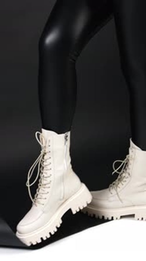 Stylish Boots with Black Leggings on Dark Background