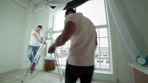 Men Working Together with Ladder and Paint